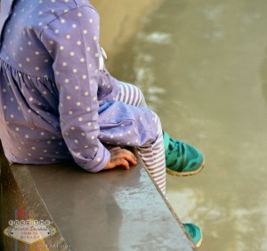 A child sits with her legs in the dolphin pool at the Mirage